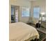 Bedroom features natural light, with a clean white comforter and office chair at 4704 Obannon Dr # D, Las Vegas, NV 89102