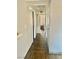 Hallway featuring wood-look flooring and neutral paint. A doorway frames a dining area at 4704 Obannon Dr # D, Las Vegas, NV 89102