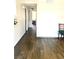 Hallway with wood-look tile floors leading to a dining area and an open room at 4704 Obannon Dr # D, Las Vegas, NV 89102