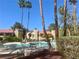 Resort-style pool area featuring tall palm trees, comfortable seating, and a tranquil setting at 4704 Obannon Dr # D, Las Vegas, NV 89102