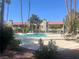 Inviting community pool surrounded by trees and patio furniture, perfect for relaxation at 4704 Obannon Dr # D, Las Vegas, NV 89102