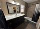 Well lit bathroom featuring a dark wood vanity, shower and toilet in a neutral color palette at 511 Credence Ave, Henderson, NV 89002