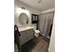 Bathroom featuring wood-look flooring, vanity with sink and storage, toilet, and shower with gray shower curtain at 511 Credence Ave, Henderson, NV 89002