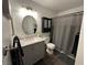 Bathroom featuring wood-look flooring, vanity with sink and storage, toilet, and shower with gray shower curtain at 511 Credence Ave, Henderson, NV 89002