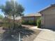 Traditional style house with desert landscaping, small tree and a walkway leading to the front door at 511 Credence Ave, Henderson, NV 89002