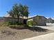 Charming single-story home with well-maintained desert landscaping and mature trees in front yard at 511 Credence Ave, Henderson, NV 89002