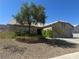 Charming single-story home with well-maintained desert landscaping and mature trees in front yard at 511 Credence Ave, Henderson, NV 89002
