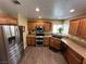A well-equipped kitchen featuring wood cabinets, stainless steel appliances, and a double basin sink at 511 Credence Ave, Henderson, NV 89002