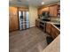 Spacious kitchen featuring stainless steel appliances, wood cabinets and hardwood flooring at 511 Credence Ave, Henderson, NV 89002