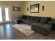 Comfortable living room featuring a large sectional couch, hardwood floors and decorative lighting at 511 Credence Ave, Henderson, NV 89002