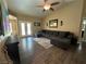 Comfortable living room featuring a large sectional couch, hardwood floors, ceiling fan and decor at 511 Credence Ave, Henderson, NV 89002