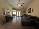 Open living room featuring hardwood floors, a fireplace, and a view into the dining room and kitchen at 511 Credence Ave, Henderson, NV 89002