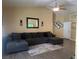Spacious living room featuring a large sectional couch, hardwood floors and decorative lighting at 511 Credence Ave, Henderson, NV 89002
