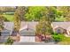 Aerial view of the home showcasing mature trees, lush green landscaping, and an attached two car garage at 5157 Future Dr, Las Vegas, NV 89130