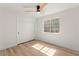 Bright bedroom features a ceiling fan, window, and closet with sliding doors at 5157 Future Dr, Las Vegas, NV 89130