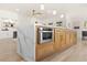 Kitchen island with built-in microwave and wood cabinets at 5157 Future Dr, Las Vegas, NV 89130