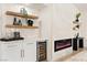 Stylish bar with a wine fridge and decorative shelves near the fireplace at 5157 Future Dr, Las Vegas, NV 89130