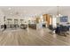 Open-concept living area featuring lots of natural light, wood floors, fireplace and a seamless flow to the kitchen at 5157 Future Dr, Las Vegas, NV 89130