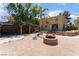 Outdoor patio area with a cozy fire pit, gazebo, and decorative elements, perfect for entertaining at 5312 Manuel Dr, Las Vegas, NV 89149