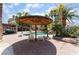 Backyard features a unique umbrella structure, pool with waterfall, covered patios and desert landscaping at 5312 Manuel Dr, Las Vegas, NV 89149