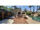 Beautiful backyard with pool, waterfall feature, outdoor kitchen, and brick patio perfect for entertaining at 5312 Manuel Dr, Las Vegas, NV 89149