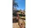 Landscaped backyard featuring green lawns, mature landscaping, and fencing at 5312 Manuel Dr, Las Vegas, NV 89149