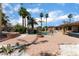 Spacious backyard featuring a pool with rock waterfall, fire pit, covered patio and mature landscaping at 5312 Manuel Dr, Las Vegas, NV 89149