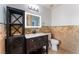 Bathroom featuring a marble countertop, cabinet, decorative tiles and vanity mirror at 5312 Manuel Dr, Las Vegas, NV 89149
