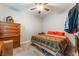 Cozy bedroom with a comfortable bed, wooden dresser, and carpeted floors at 5312 Manuel Dr, Las Vegas, NV 89149