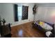 Bedroom with wood floor, window with game controller curtains, and closet at 5312 Manuel Dr, Las Vegas, NV 89149