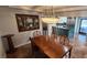Dining room open to kitchen featuring an ocean-themed painting and modern chandelier at 5312 Manuel Dr, Las Vegas, NV 89149