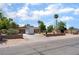 A wide shot of the property showing the front exterior, desert landscaping, and a two-car garage at 5312 Manuel Dr, Las Vegas, NV 89149