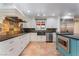 Modern kitchen with stainless steel appliances, custom cabinets, and blue kitchen island at 5312 Manuel Dr, Las Vegas, NV 89149