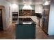 Modern kitchen with stainless steel appliances, large island, and dark countertops at 5312 Manuel Dr, Las Vegas, NV 89149