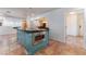 Open kitchen featuring a blue kitchen island with stone countertops and stainless steel microwave at 5312 Manuel Dr, Las Vegas, NV 89149