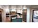 Spacious kitchen with stainless steel appliances, central island and backyard access at 5312 Manuel Dr, Las Vegas, NV 89149