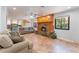 An expansive living space with tiled floors, a fireplace, and views into the kitchen and backyard at 5312 Manuel Dr, Las Vegas, NV 89149