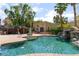 Beautiful backyard pool area with a gazebo, waterfall feature, and lush tropical landscaping at 5312 Manuel Dr, Las Vegas, NV 89149