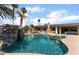 Inviting pool area with rock waterfall feature, palm trees, and ample space for outdoor relaxation at 5312 Manuel Dr, Las Vegas, NV 89149