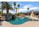 Sparkling swimming pool with a rock waterfall feature and lush landscaping, creating a private backyard oasis at 5312 Manuel Dr, Las Vegas, NV 89149