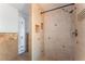 Shower stall featuring pebble flooring, tiled walls, and built-in shelves at 5312 Manuel Dr, Las Vegas, NV 89149