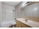 Bathroom features a shower-tub combo, a white toilet, and a vanity with a mirror at 5620 Pinecone Pl, Las Vegas, NV 89108