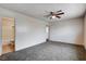 Carpeted bedroom with ceiling fan; bathroom is connected to it at 5620 Pinecone Pl, Las Vegas, NV 89108