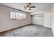 Comfortable bedroom with plush carpeting and natural light from the window at 5620 Pinecone Pl, Las Vegas, NV 89108
