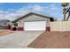 A single-story home features an attached two-car garage and a well-maintained front yard at 5620 Pinecone Pl, Las Vegas, NV 89108