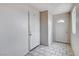 Inviting foyer with tile flooring, featuring a coat closet and a front door with decorative window at 5620 Pinecone Pl, Las Vegas, NV 89108