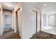 Inviting hallway with neutral carpet, closet space, and access to other rooms at 5620 Pinecone Pl, Las Vegas, NV 89108