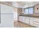 Well-lit kitchen with ample cabinet space and a large window overlooking the backyard at 5620 Pinecone Pl, Las Vegas, NV 89108