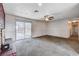 Open living room with sliding glass doors to the backyard and brick fireplace at 5620 Pinecone Pl, Las Vegas, NV 89108