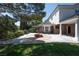 Inviting backyard featuring a brick patio, fire pit, and lush landscaping at 5860 N Campbell Rd, Las Vegas, NV 89149